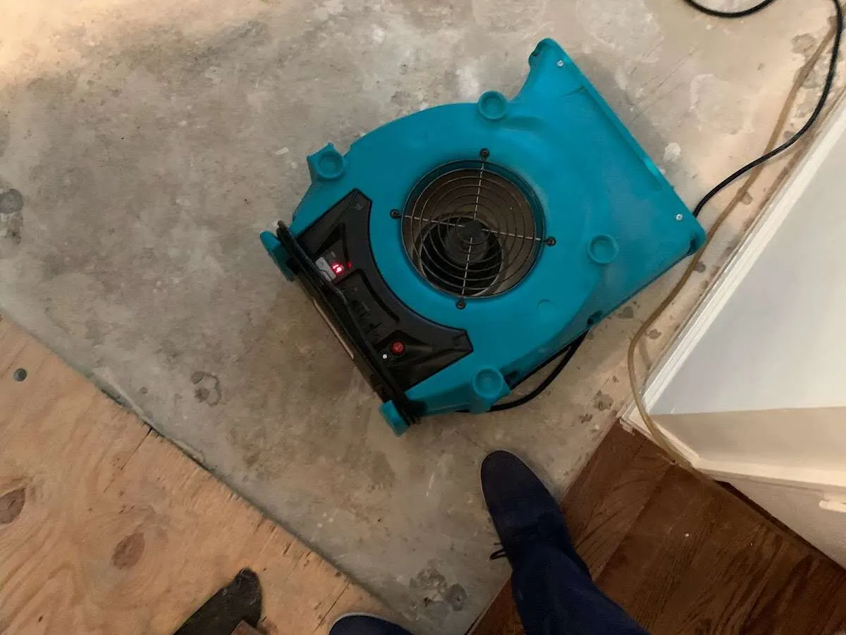 Air mover drying subfloor during Commercial Water Damage Restoration in Sauk Rapids